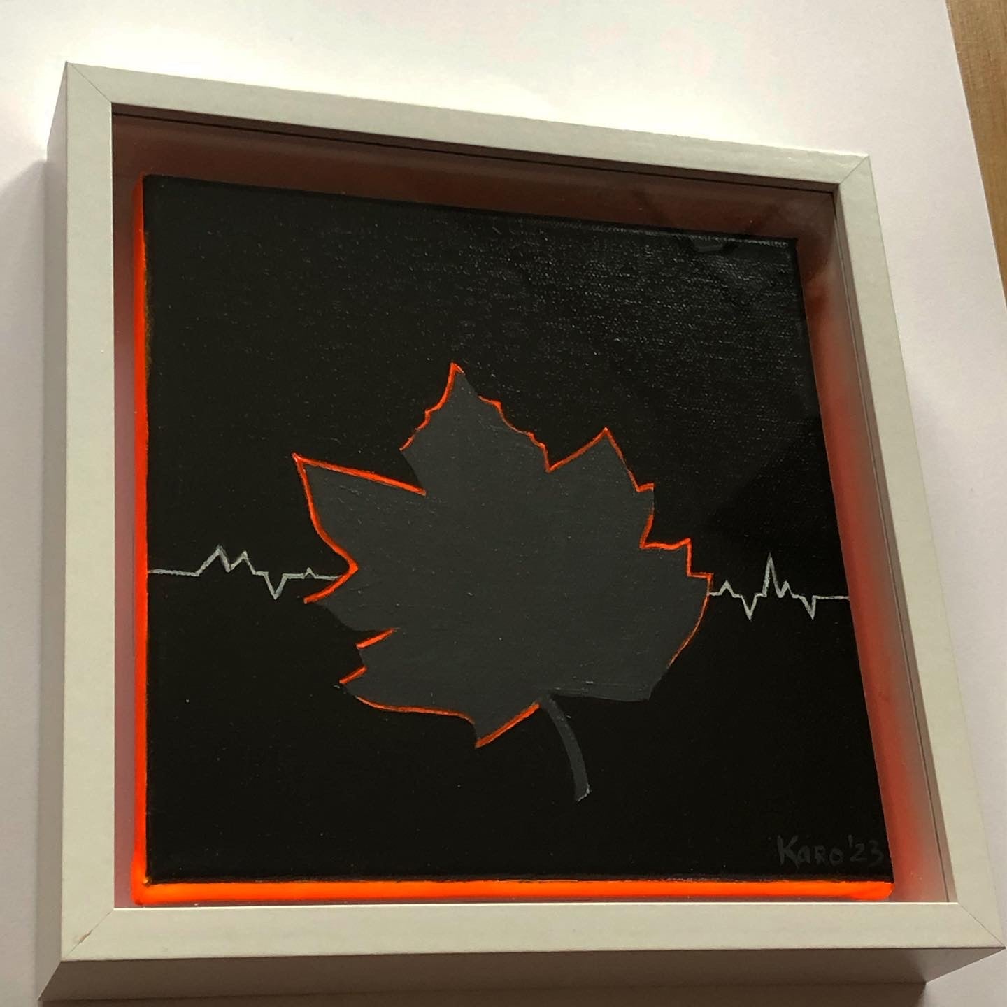 Maple leaf canvas painting with neon orange edges